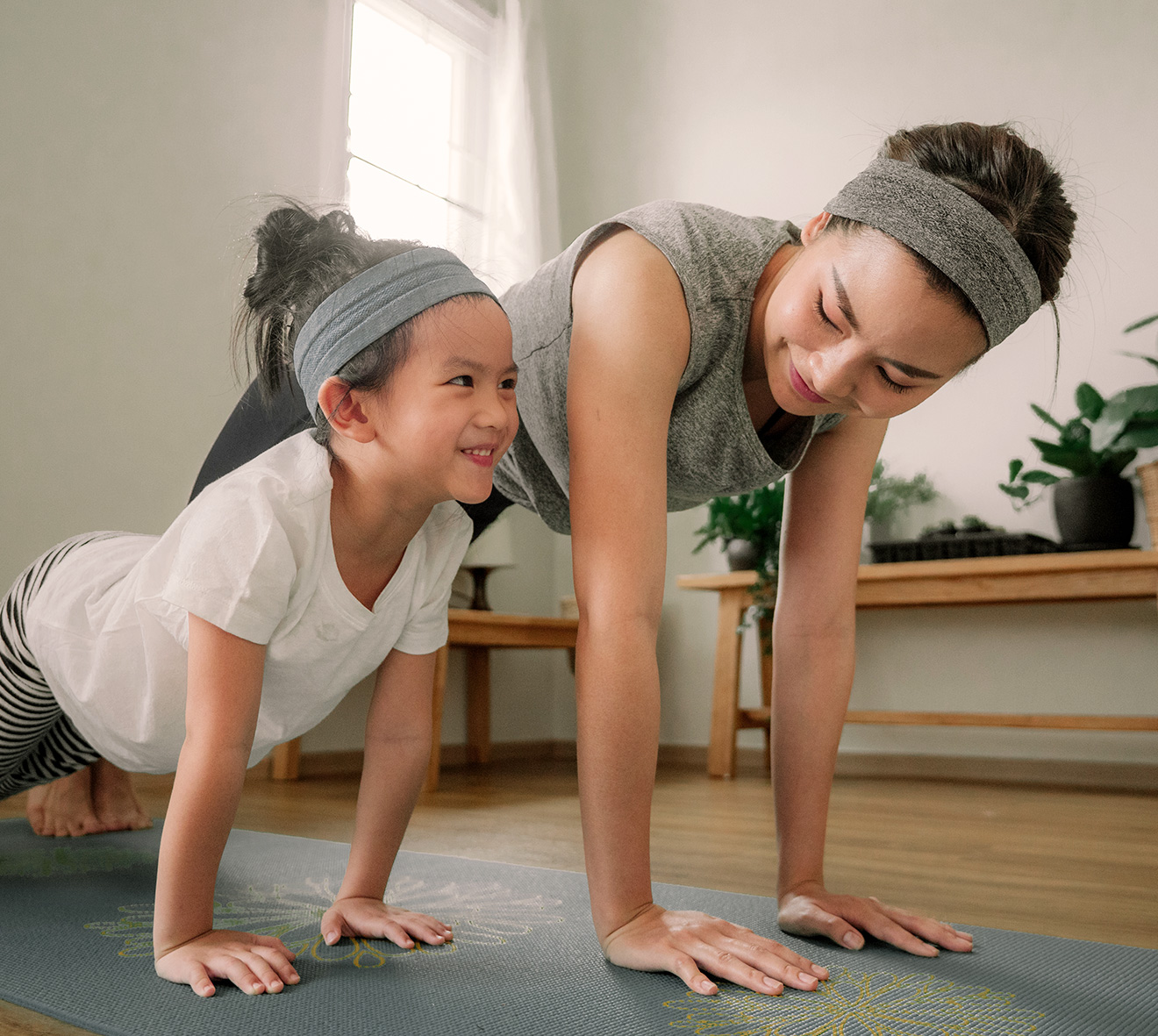 A mom doing yoga with her daughter