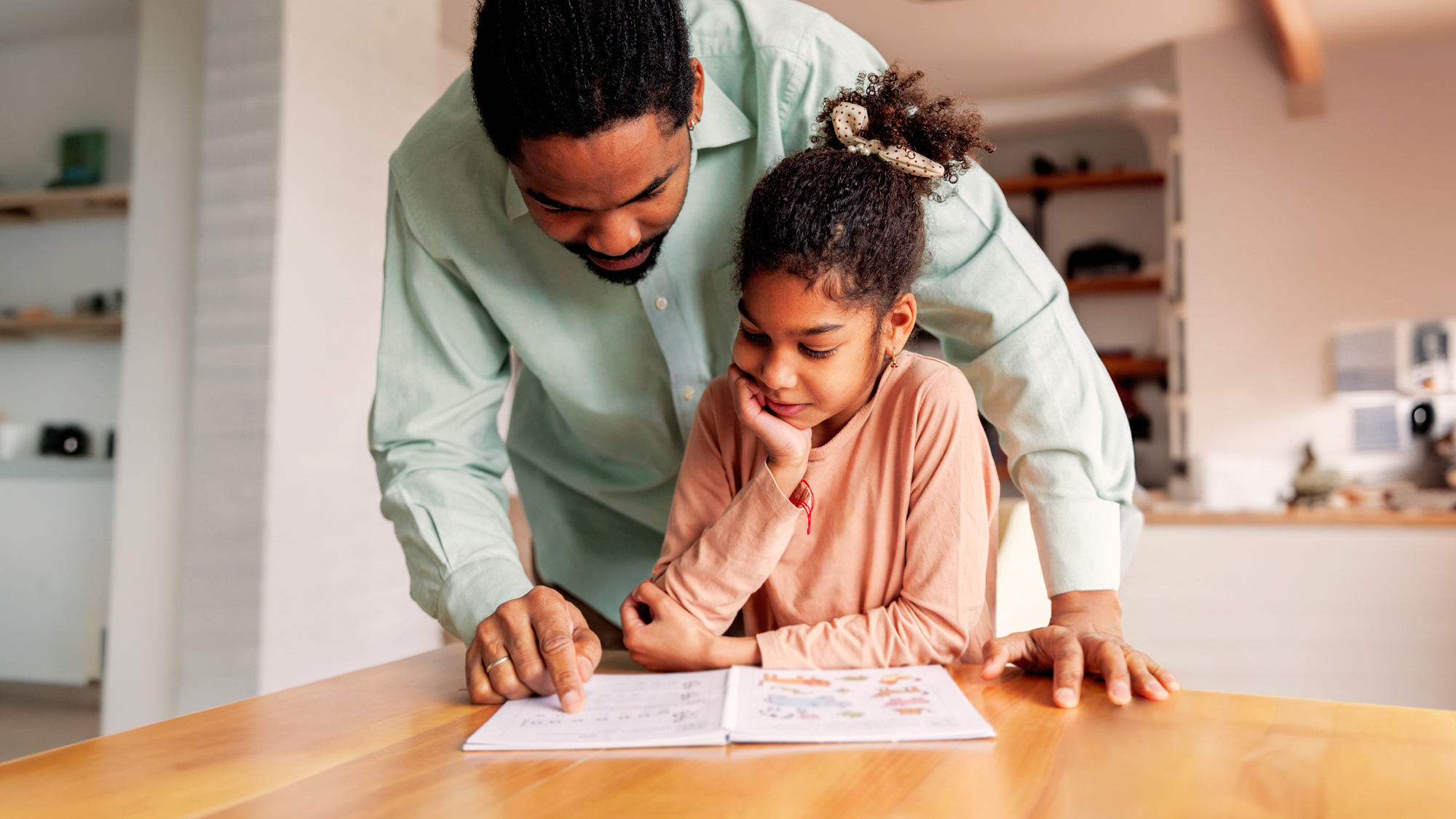 a dad helping his daughter with his homework